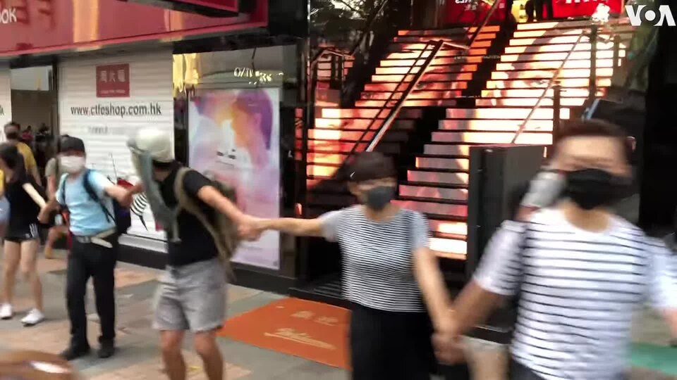 Lawmakers Seek — Hong Kong Protesters Defy Mask Ban By Forming Human Chain