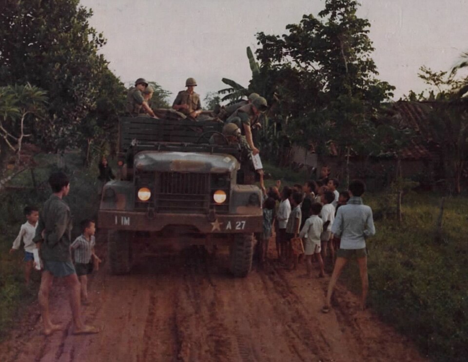 Aid Convoy Enters — 1st Medical Battalion aid convoy enters a village for a MEDCAP